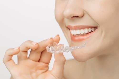 Hong Kong woman smiling with straight white teeth as she prepares to wear a clear aligner.