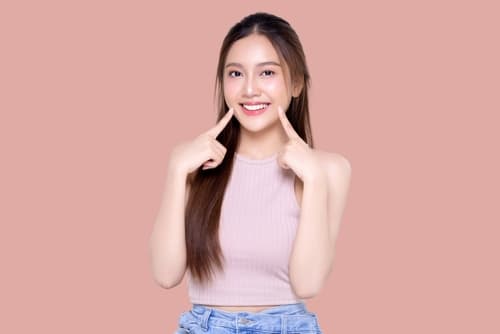 Confident young Hong Kong student smiling with aligned teeth, showcasing results of traditional orthodontic treatment